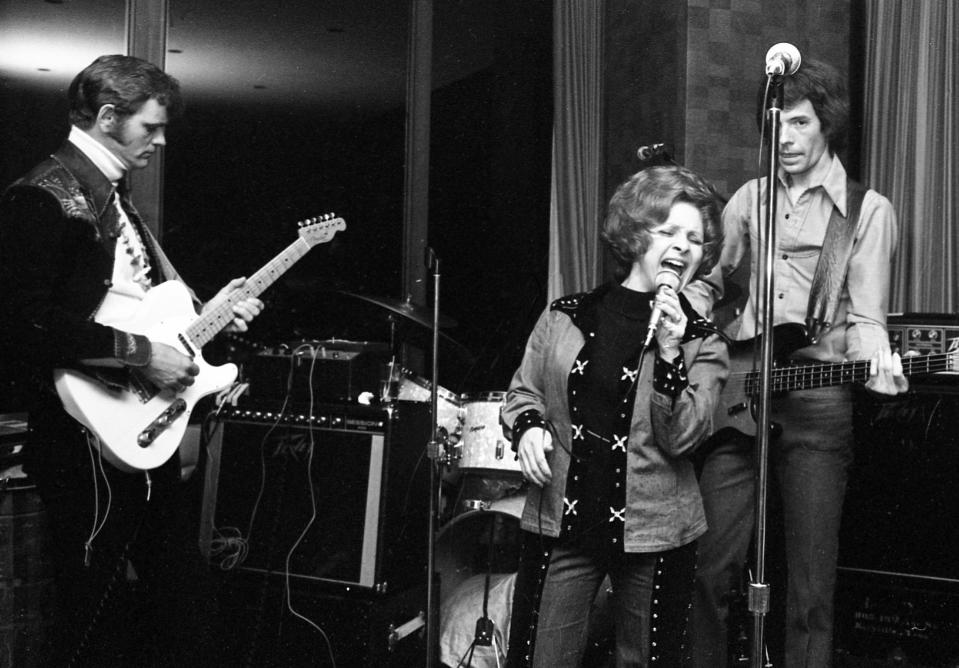 Brenda Lee, center, belts out one of her hits during the after-party for the world premiere of "W.W. and the Dixie Dancekings" in Nashville on Feb. 4, 1975. Film co-star Jerry Reed, left, provides the guitar licks.