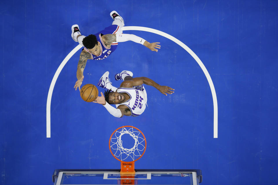 Sacramento Kings' Buddy Hield, bottom leaps for a rebound against Philadelphia 76ers' Danny Green during the first half of an NBA basketball game, Saturday, March 20, 2021, in Philadelphia. (AP Photo/Matt Slocum)