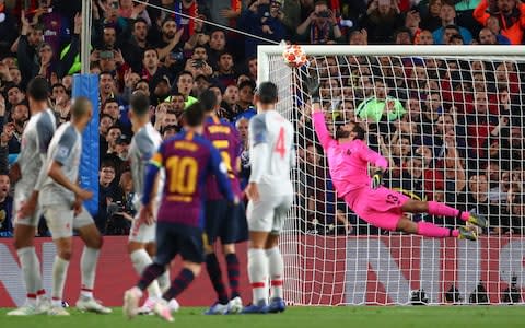 Alisson dives as far as he can but still cannot reach Messi's brilliant free-kick - Credit: Robbie Jay Barratt - AMA/Getty Images