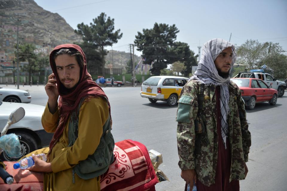 Taliban fighters stand along a road in Kabul on Aug. 18, 2021 following the Taliban stunning takeover of Afghanistan.