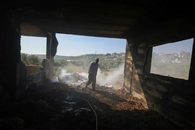 A Palestinian inspects the damage to a home in the village of Al-Mughayyir near Ramallah in theoccupied West Bank, after an attack by Israeli settlers (JAAFAR ASHTIYEH)