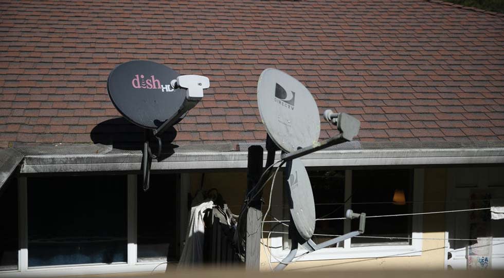  Dish Network and DirecTV dishes side by side. 