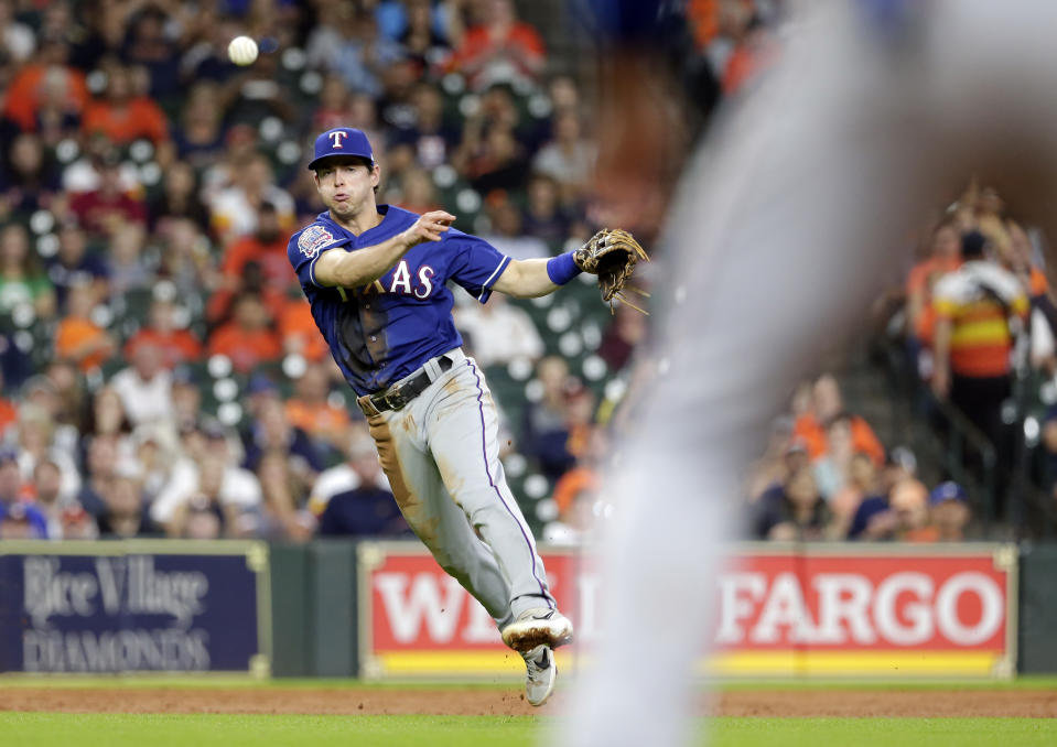 With the bases loaded and two out, Texas Rangers third baseman Nick Solak fields the hit by Houston Astros George Springer to first base for the out to end the second inning of a baseball game Wednesday, Sept. 18, 2019, in Houston. (AP Photo/Michael Wyke)