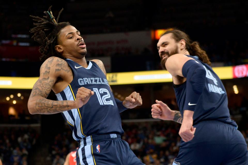 Memphis Grizzlies guard Ja Morant (12) and center Steven Adams (4) react after Morant scored in the first half of an NBA basketball game against the Washington Wizards, Saturday, Jan. 29, 2022, in Memphis, Tenn. (AP Photo/Brandon Dill)