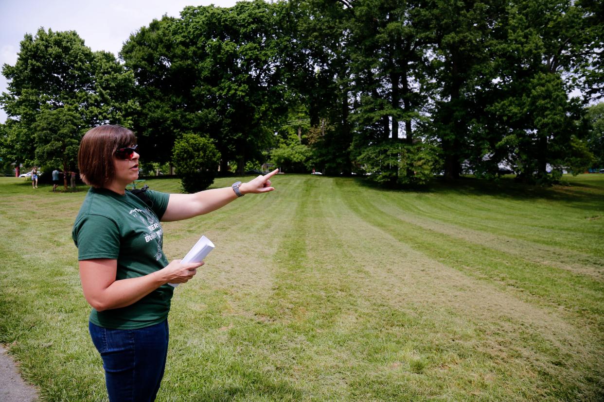 Cynthia Duvall of the Preserve Burnet Woods board points out the proposed location of a new dog park at Burnet Woods in the Clifton neighborhood of Cincinnati on Thursday, May 19, 2022. City plans to install a dog park in the north-east corner of the park has drawn criticism from local groups and neighbors.  