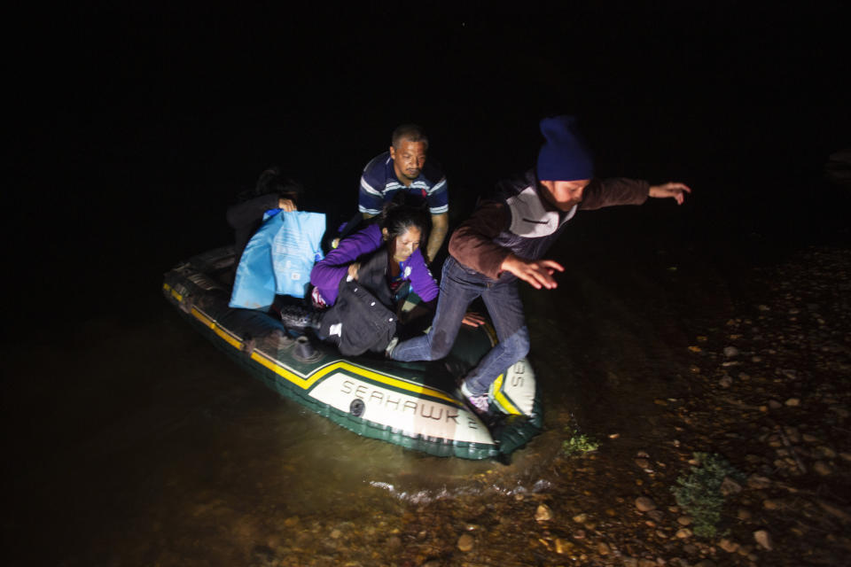Migrant families, mostly from Central American countries, wade through shallow waters after being delivered by smugglers on small inflatable rafts on U.S. soil in Roma, Texas, Wednesday, March 24, 2021. (AP Photo/Dario Lopez-Mills)