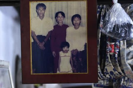 A family photograph of slain journalist Par Gyi, his wife Than Dar and their daughter posing with Aung San Suu Kyi is shown at their home, in Yangon October 28, 2014. REUTERS/Soe Zeya Tun