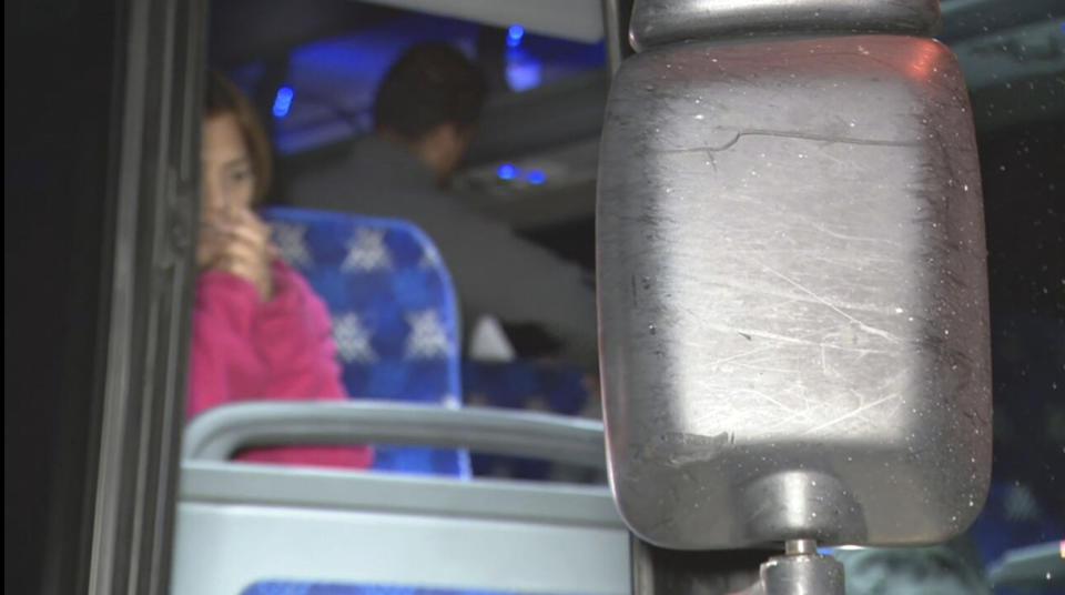 This image provided by WJLA shows migrant families on a bus near the Vice President's residence after they arrived in Washington, Saturday, Dec. 24, 2022. Local organizers in Washington say three buses of recent migrant families arrived from Texas near the home in record-setting cold on Christmas Eve. Texas authorities have not confirmed their involvement. (WJLA via AP)