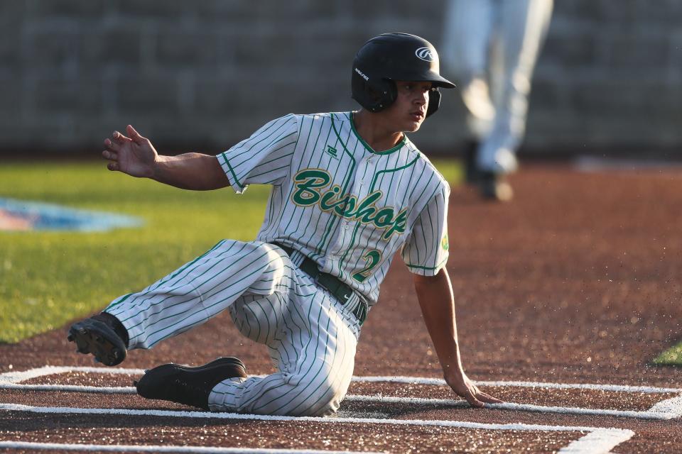 Bishop's Gabe Garcia (2) slides across home plate to score a run in a quarterfinal playoff game against Banquete at Cabaniss Field on May 18. The Badgers won by the mercy rule 10-0 in the fifth inning.