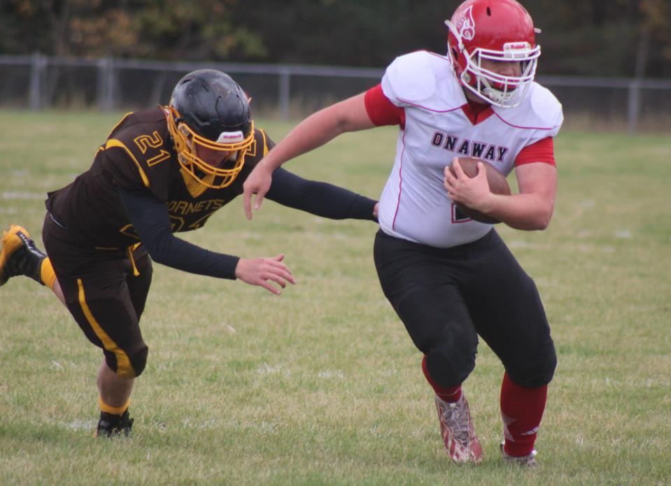 Onaway senior running back Justin Kramer-St. Germain (right) heads for the end zone while Pellston senior Jacob Rizzardi (21) chases during the first half of a football game at Pellston on Saturday.