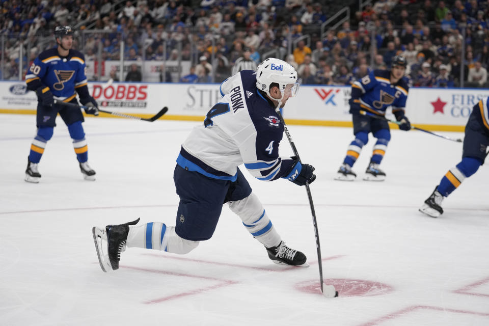 Winnipeg Jets' Neal Pionk (4) scores during the first period of an NHL hockey game against the St. Louis Blues Tuesday, Nov. 7, 2023, in St. Louis. (AP Photo/Jeff Roberson)