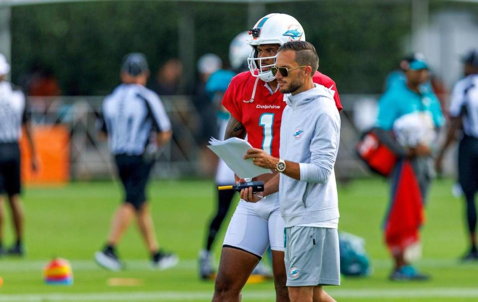 Miami Dolphins head coach Mike McDaniel talks with Miami Dolphins quarterback Tua Tagovailoa (1) during a joint practice with the Atlanta Falcons at Baptist Health Training Complex in Hard Rock Stadium on Wednesday, August 9, 2023 in Miami Gardens, Florida.