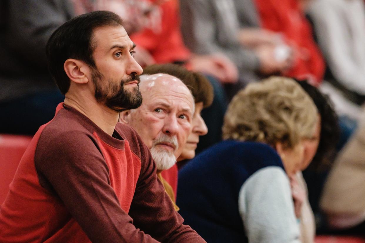 Nick Homrighausen is seen attending the Dover boys D1 semifinal basketball game against Austintown Fitch, Wednesday, Feb. 23. The Falcons upset the Tornadoes, 60-57. Pictured at center is Dover Mayor Richard Homrighausen.