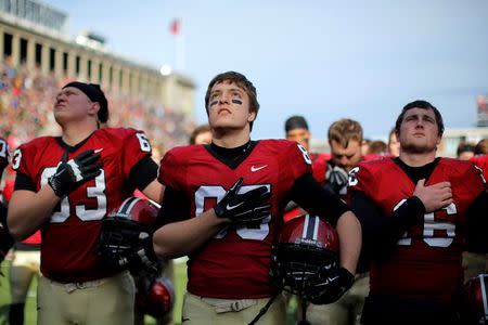Harvard University football players stand for the national anthem in Allston, Massachusetts, November 2014. REUTERS/Brian Snyder