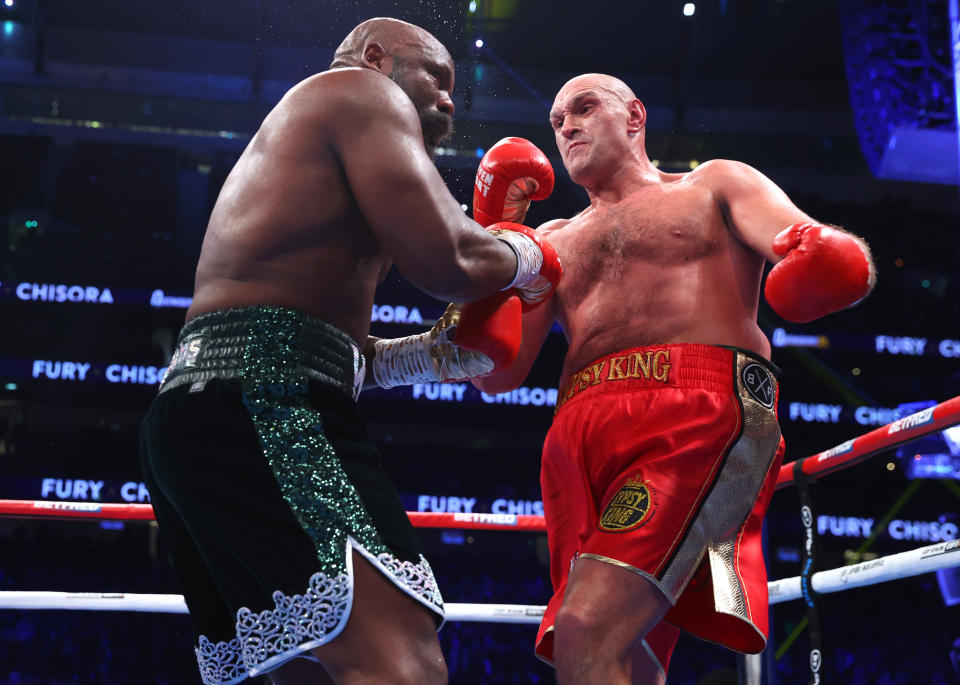 LONDON, ENGLAND - DECEMBER 03: Derek Chisora (L) and Tyson Fury (R) exchange punches during their WBC heavyweight championship fight, at Tottenham Hotspur Stadium on December 03, 2022 in London, England. (Photo by Mikey Williams/Top Rank Inc via Getty Images)