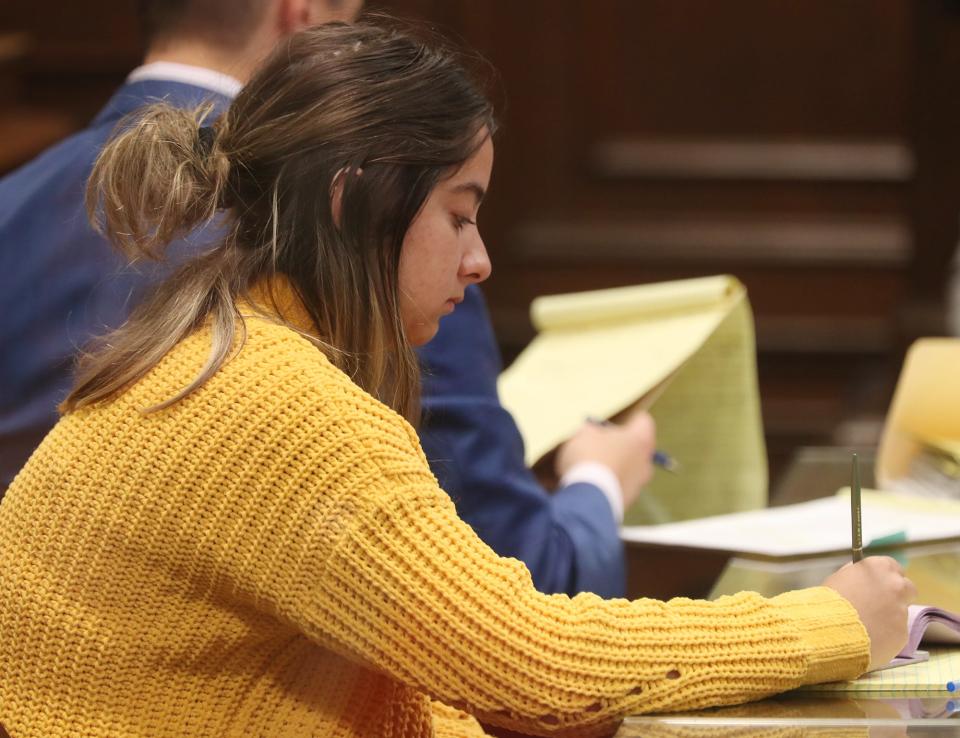 Sydney Powell, writes as she listens to prosecutor's witness, clinical psychologist Sylvia O'Bradovich of Summit Psychological Services, during her trial in Summit County Common Pleas Judge Kelly McLaughlin's courtroom. Powell is on trial for the stabbing death of her mother.