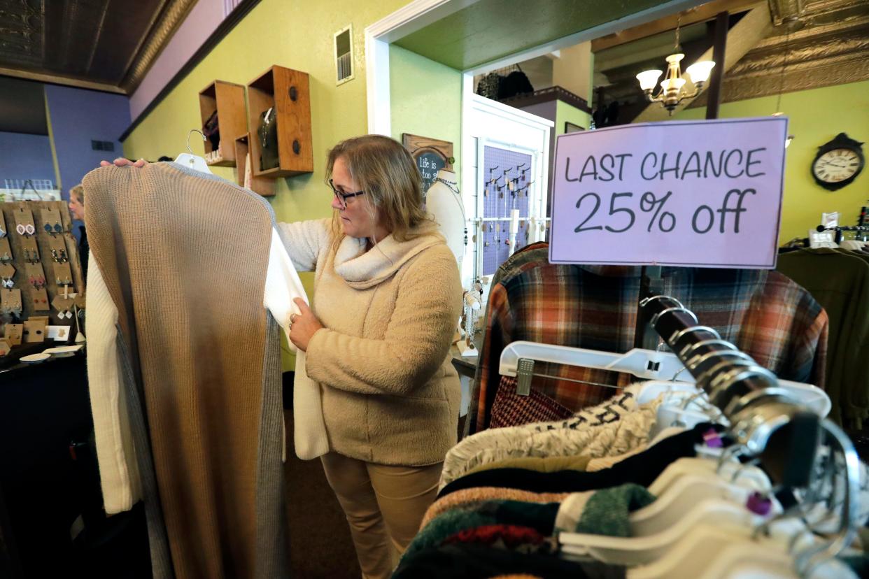 Jennifer Block of Green Bay checks out clothing specials at Lillians of Appleton Friday, November 17, 2023, in downtown Appleton, Wis.