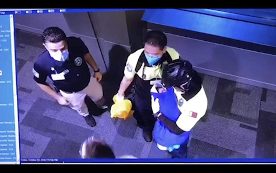 This image made from Oct. 2, 2020 surveillance camera footage obtained by the website Doha News shows officials care for an abandoned baby at Hamad International Airport in Doha, Qatar. Qatar apologized Wednesday, Oct. 28, 2020, after authorities forcibly examined female passengers from a Qatar Airways flight to Sydney to try to identify who might have given birth to the abandoned newborn baby, even as Australia said it was only one of 10 flights subjected to the searches. (Courtesy of Doha News via AP)