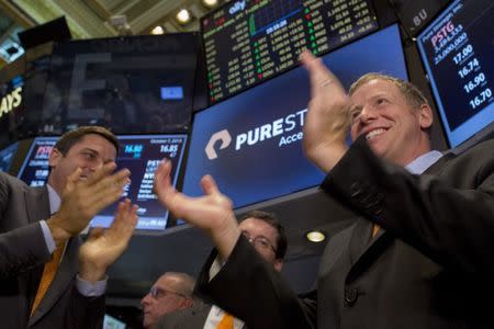 Pure Storage Inc. CEO Scott Dietzen (R) celebrates his company's IPO on the floor of the New York Stock Exchange October 7, 2015. REUTERS/Brendan McDermid