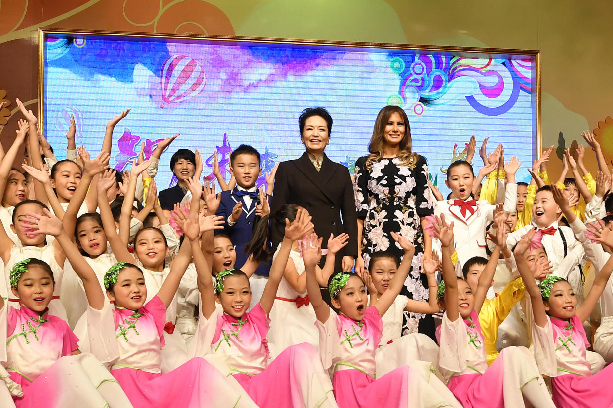 First lady Melania Trump and China’s first lady, Peng Liyuan, are surrounded by students after a cultural performance during a visit to Banchang Primary School in Beijing on Nov. 9. (Photo: Reuters/Greg Baker/Pool)