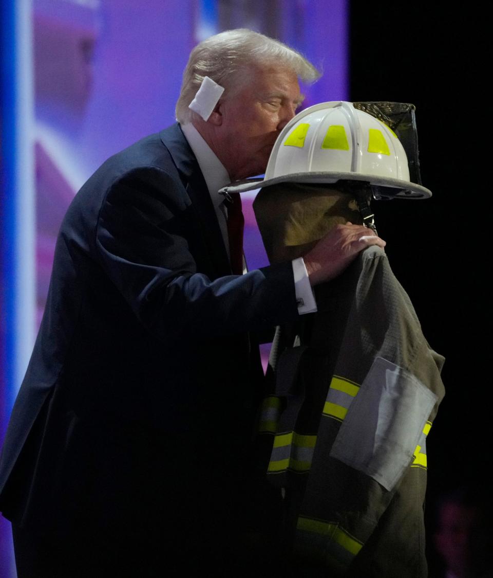Republican presidential nominee Donald J. Trump kisses the uniform of the man killed at Saturday during a rally before delivering his nomination acceptance speech during the final day of the Republican National Convention at the Fiserv Forum. The final day of the RNC featured a keynote address by Republican presidential nominee Donald Trump.