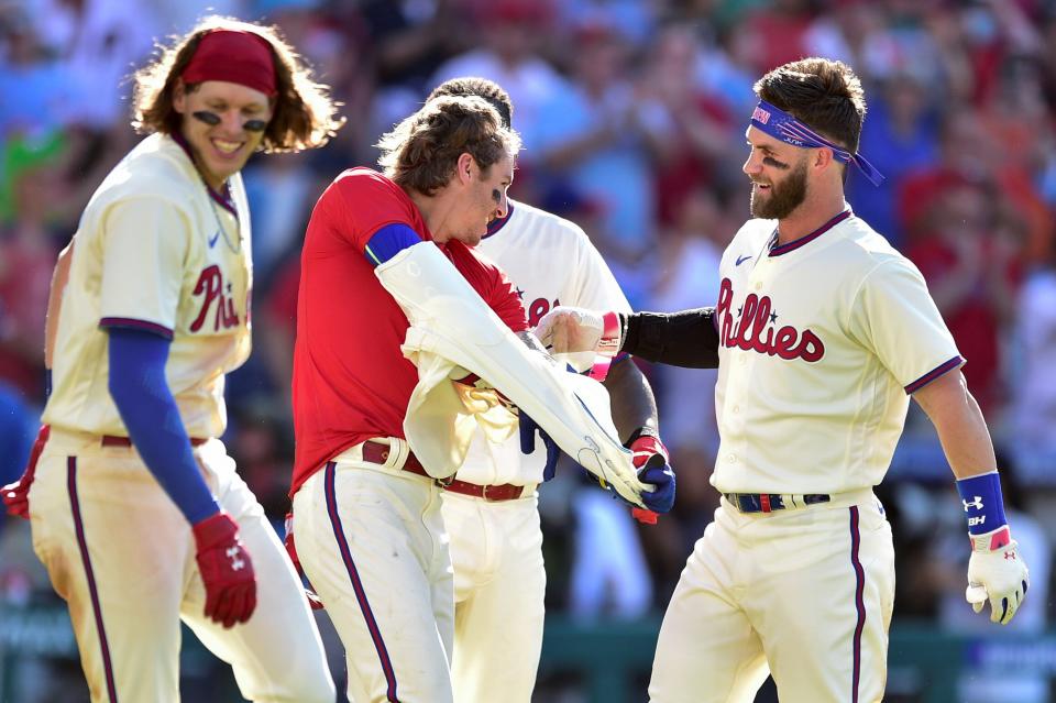 The Phillies' Bryson Stott, center, celebrates his walk-off home run Sunday with teammates Bryce Harper, right, and Alec Bohm.