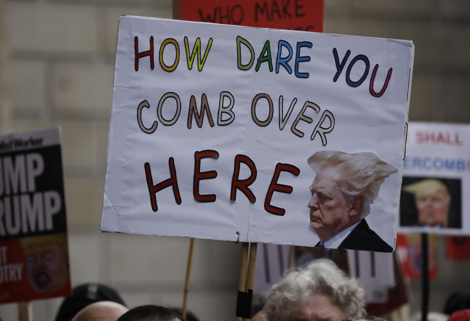 Protesters got creative with their signs. (AP Photo/Matt Dunham)