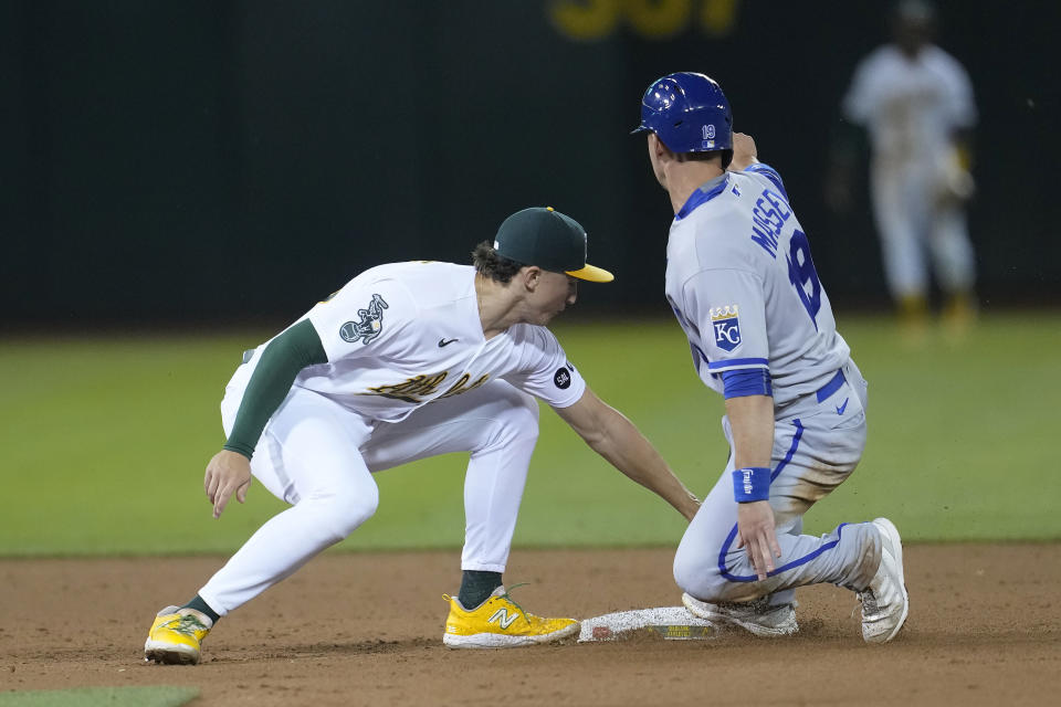 Kansas City Royals' Michael Massey, right, is tagged out trying to steal second base by Oakland Athletics second baseman Zack Gelof during the eighth inning of a baseball game in Oakland, Calif., Monday, Aug. 21, 2023. (AP Photo/Jeff Chiu)