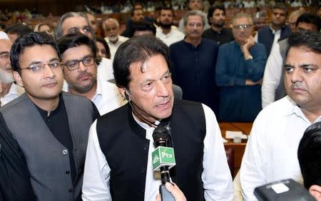 FILE PHOTO: Imran Khan (C), chairman of Pakistan Tehreek-e-Insaf (PTI) political party speaks after he was elected as Prime Minister at the National Assembly (Lower House of Parliament) in Islamabad, Pakistan August 17, 2018. National Assembly Handout via REUTERS