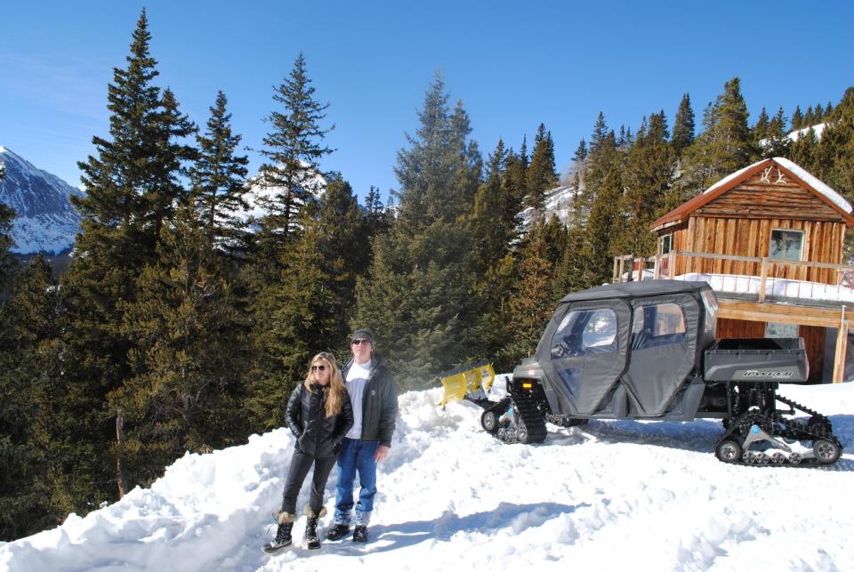 In this Jan. 24, 2014 photo, Andy and Ceil Barrie stand for a photo next to their mining cabin near Breckenridge, Colo. Summit County wants to condemn 10 acres of land that belongs to the Barrie's through the controversial power of eminent domain. (AP Photo/Nicholas Riccardi)