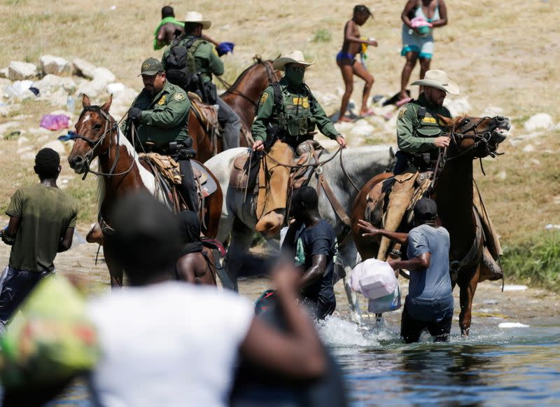 Migrants collecting food try to evade law enforcement at the U.S.-Mexico border