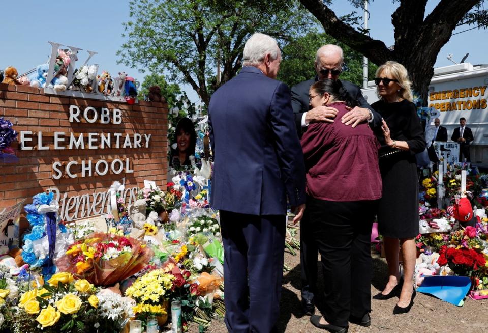 President Joe Biden hugs Mandy Gutierrez, Principal at Robb Elementary School, at the site of the massacre on 29 May (Reuters)