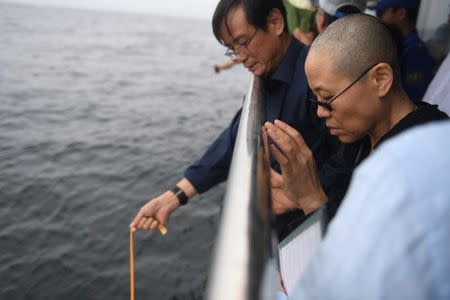 Liu Xia, wife of deceased Chinese Nobel Peace Prize-winning dissident Liu Xiaobo and other relatives attend his sea burial off the coast of Dalian, China in this photo released by Shenyang Municipal Information Office on July 15, 2017. Shenyang Municipal Information Office/via REUTERS