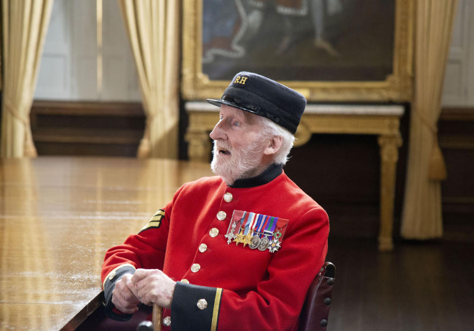 In this image taken on April 29, 2020 World War II veteran Bob Sullivan poses for a photo at the Royal Hospital Chelsea in London. Forgive British World War II veteran Bob Sullivan for being unfussed about VE-Day. After all, on May 8, 1945, he was lying in Cossham Hospital, having been wounded in the closing days of the fight to defeat the Nazis. As he couldn't move because of a plaster cast on his leg, he wasn't even able to attend a celebratory supper.(Liam Best via AP)