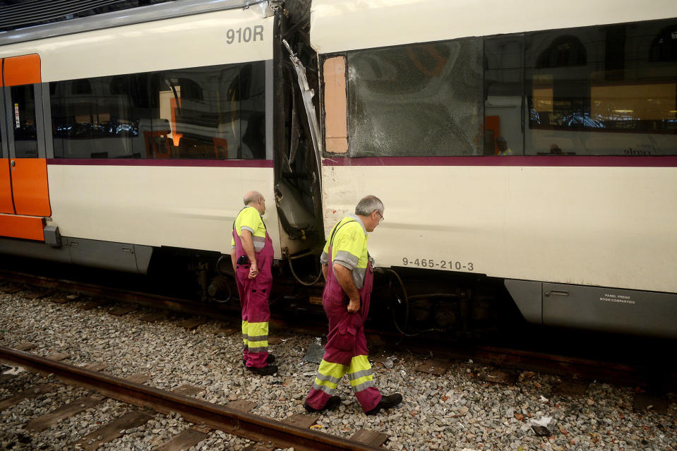 Workers look at the damage