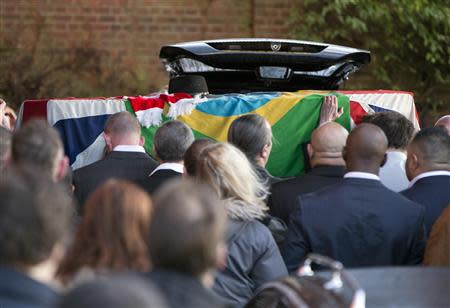 The coffin of Ronnie Biggs is taken into Golders Green Crematorium in north London January 3, 2014. REUTERS/Neil Hall