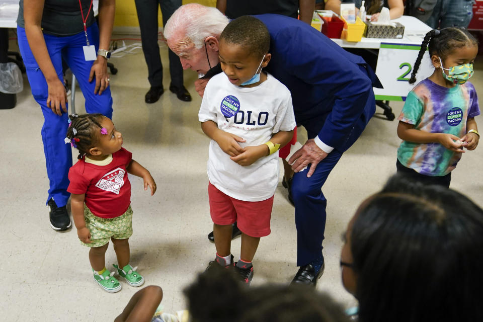 President Joe Biden speaks to a child as he visits a COVID-19 vaccination clinic at the Church of the Holy Communion Tuesday, June 21, 2022, in Washington. (AP Photo/Evan Vucci)