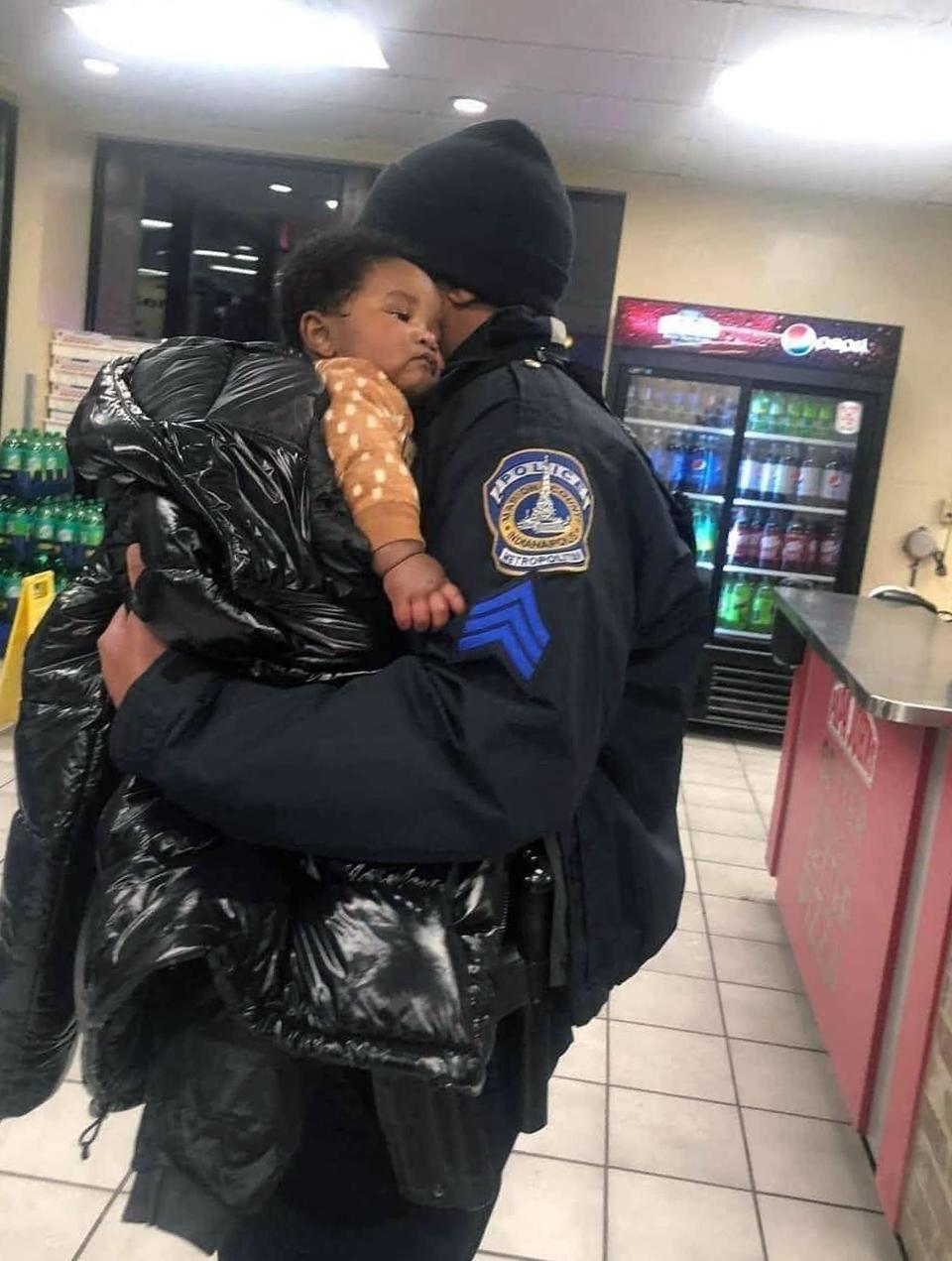 Indianapolis Metropolitan Police Sgt. Shawn Anderson holds 5-month-old Kason Thomas after the missing twin had been found at 6:46 p.m. Thursday inside his mother's stolen 2010 Honda Accord in the parking lot of a Papa John's pizza shop at 955 Indiana Ave. near 10th Street in Indianapolis -- about 175 miles from where he was abducted Monday night from a Donatos Pizza in Columbus' Short North.