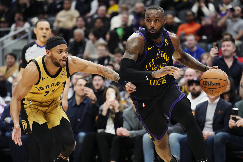 Los Angeles Lakers forward LeBron James (23) drives past Toronto Raptors forward Bruce Brown (11) during the second half of an NBA basketball game Tuesday, April 2, 2024, in Toronto. (Frank Gunn/The Canadian Press via AP)