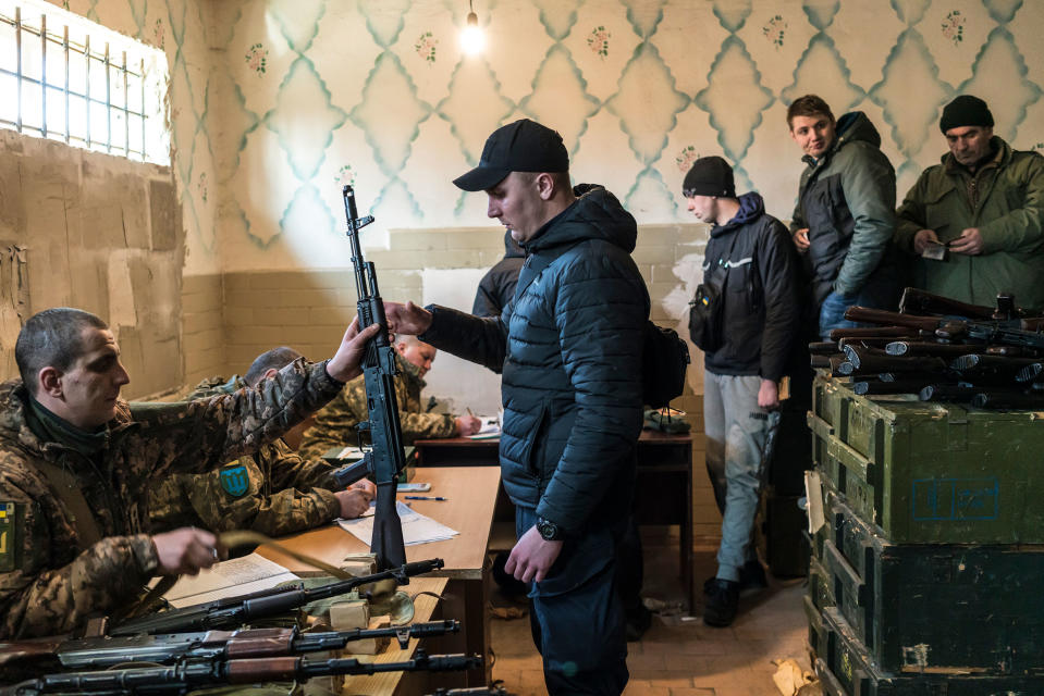 Civilian volunteers receive weapons, in a nationwide campaign to recruit, register and draft men for the war against Russia, in Fastiv, Ukraine, on Feb. 25.<span class="copyright">Bendan Hoffman—The New York Times/Redux</span>