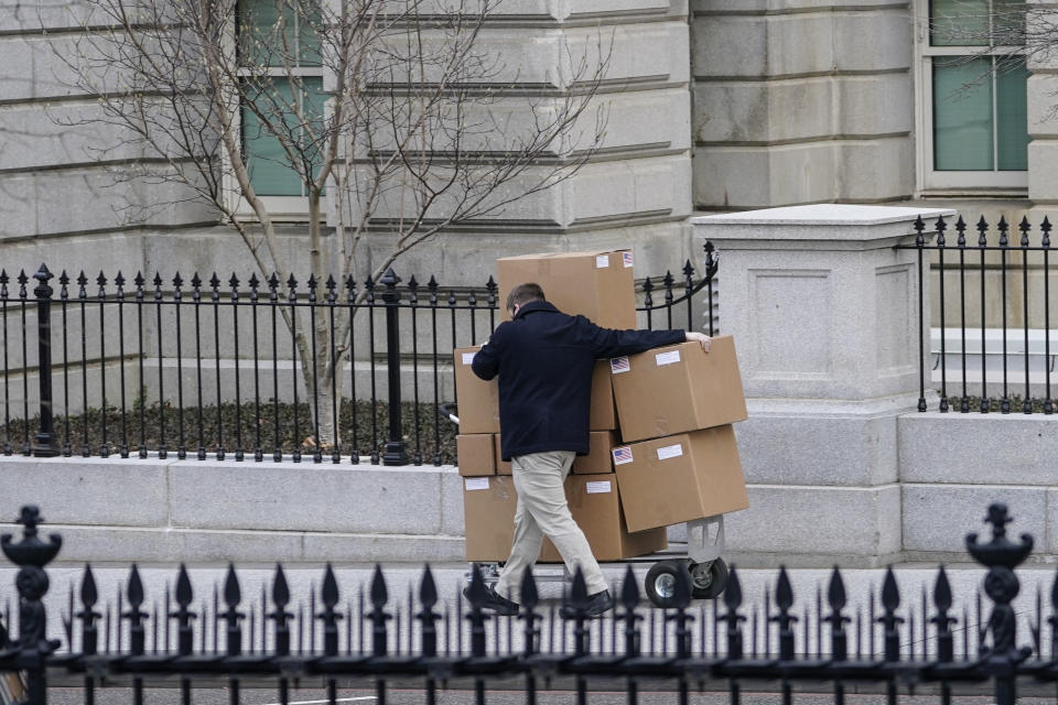 WASHINGTON, DC - JANUARY 15: A man pushes a large cart full of boxes along West Executive Avenue between the West Wing of the White House and the Eisenhower Executive Office Building on January 15, 2021 in Washington, DC. According to recent news reports, President Donald Trump is slated to leave Washington the morning of Jan. 20th, hours before President-elect Joe Biden will be sworn-in as president. (Photo by Drew Angerer/Getty Images)