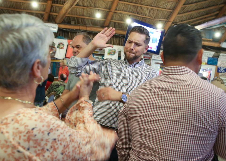 State Rep. John Snyder celebrates as Amy Pritchett (left), a Martin County School Board member, informs him he won his reelection to the House District 86 seat on Tuesday, Nov. 8, 2022, at Harry and the Natives in Hobe Sound. Snyder beat his Democratic challenger Ray Denzel. "I predict it's not going to be a red wave tonight, it's going to be a red tsunami," said Snyder, during his acceptance speech. "We are going to send a message to the rest of the country, that's why the Democrats have already raised a white flag they don't want to even play here in Florida because this is a place for liberty and we are keeping Florida free. We've got a lot of work ahead of us over the next two years."