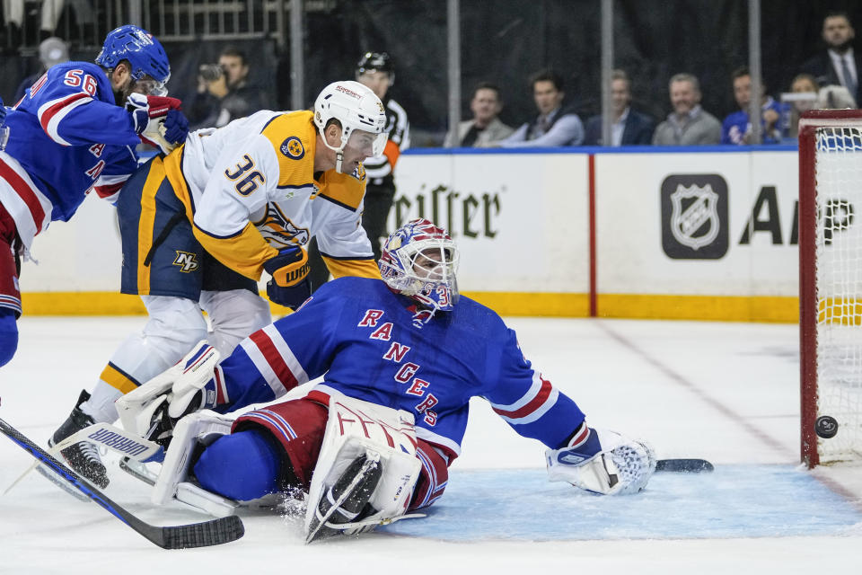 Nashville Predators' Cole Smith (36) shoots the puck past New York Rangers goaltender Igor Shesterkin, bottom, during the first period of an NHL hockey game Thursday, Oct. 19, 2023, in New York. (AP Photo/Frank Franklin II)