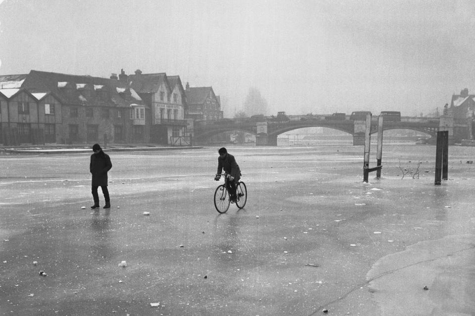 A man riding a bike on the frozen River Thames in 1963. (PA)