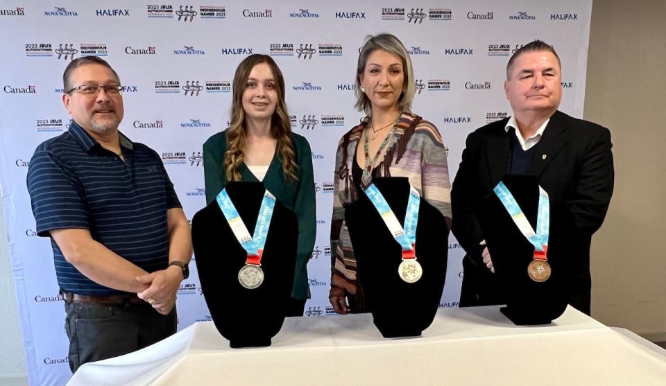 Shown with the new North American Indigenous Games medals are Millbrook Chief Bob Gloade (left), student Ella Scothorn, Mi'kmaw artist Tayla Fern Paul and George "Tex" Marshall, president of the 2023 NAIG Host Society. 