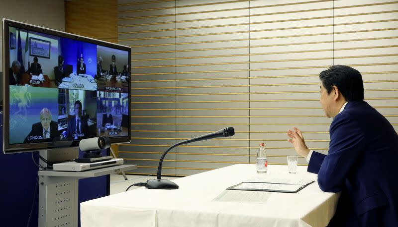 Japan's Prime Minister Shinzo Abe talks with other G7 leaders during a video conference at his official residence in Tokyo, Japan