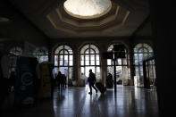 A man pulls his luggage at the Gare de l'Est train station Tuesday, Dec. 10, 2019 in Paris. Only about a fifth of French trains ran normally Tuesday, frustrating tourists finding empty train stations, and most Paris subways were at a halt. French airport workers, teachers and others joined nationwide strikes Tuesday as unions cranked up pressure on the government to scrap changes to the national retirement system. (AP Photo/Francois Mori)