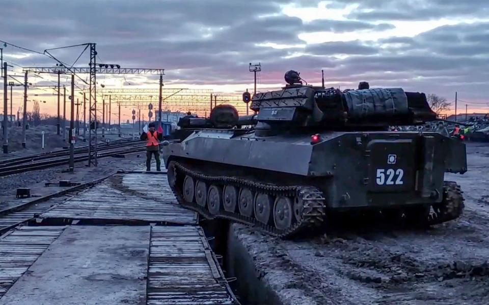 This handout video grab released by the Russian Defence Ministry on February 15, 2022, shows a Russian tank leaving for Russia after joint exercises of the armed forces of Russia and Belarus as part of an inspection of the Union State's Response Force, at a firing range near Brest. - Russia said on February 15, 2022 it was pulling back some of its forces near the Ukrainian border to their bases, in what would be the first major step towards de-escalation in weeks of crisis with the West. The move came amid an intense diplomatic effort to avert a feared Russian invasion of its pro-Western neighbour and after Moscow amassed more than 100,000 troops near Ukraine's borders. (Photo by Handout / Russian Defence Ministry / AFP) / RESTRICTED TO EDITORIAL USE - MANDATORY CREDIT "AFP PHOTO / RUSSIAN DEFENCE MINISTRY" - NO MARKETING - NO ADVERTISING CAMPAIGNS - DISTRIBUTED AS A SERVICE TO CLIENTS (Photo by HANDOUT/Russian Defence Ministry/AFP via Getty Images) - HANDOUT /AFP