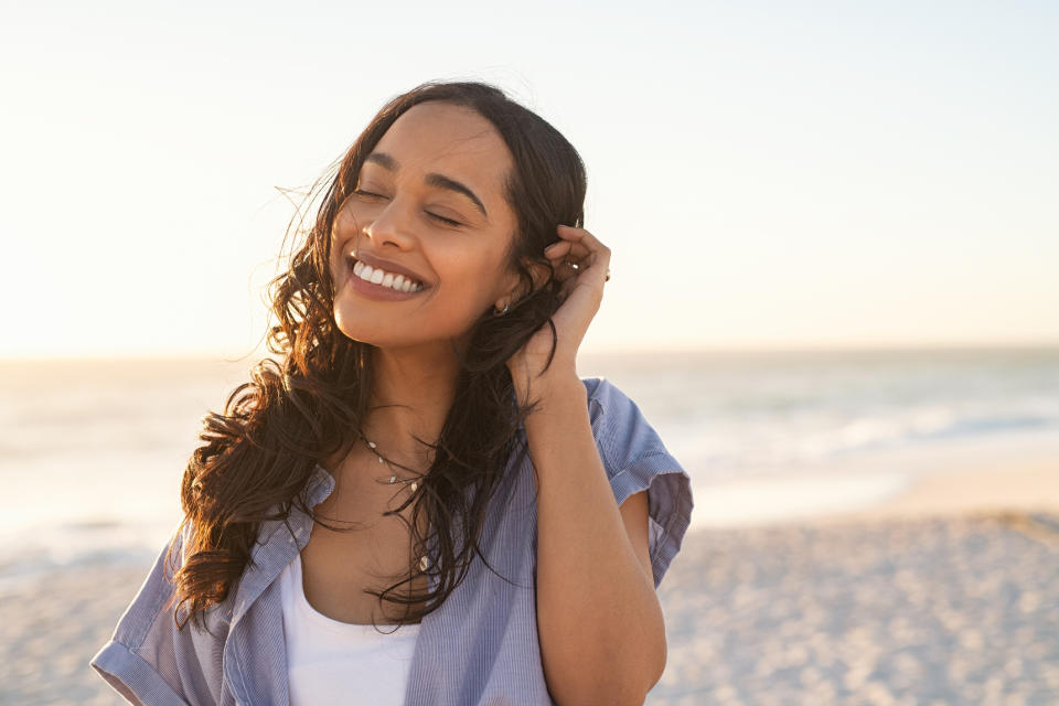 A woman at the beach smiling