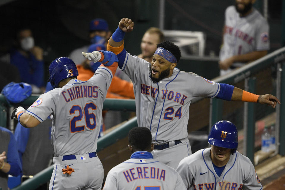 New York Mets' Robinson Chirinos (26) celebrates his two-run home run with Robinson Cano (24) during the fifth inning of the team's baseball game against the Washington Nationals, Thursday, Sept. 24, 2020, in Washington. (AP Photo/Nick Wass)